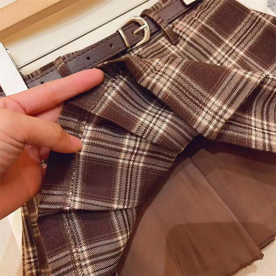 Girls cotton plaid pleated A-line skirt on a hanger, showing its length and pattern.
