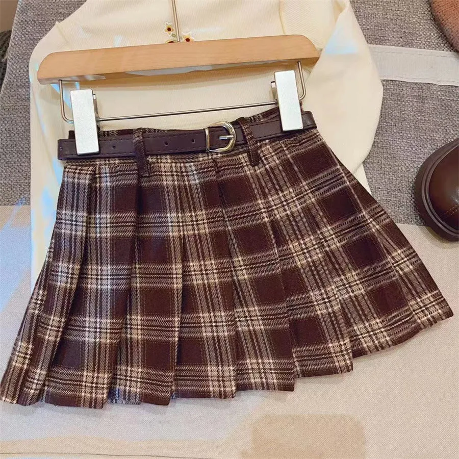 Girls cotton plaid pleated A-line skirt on a hanger, showing its length and pattern.