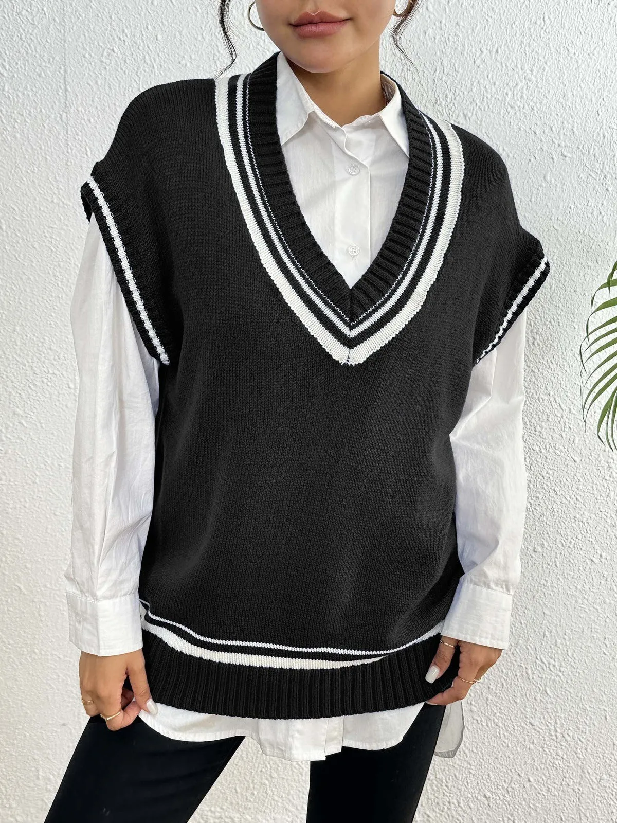 Women's college style wool vest sweater in loose fit pullover design showing black, blue and coffee colour options