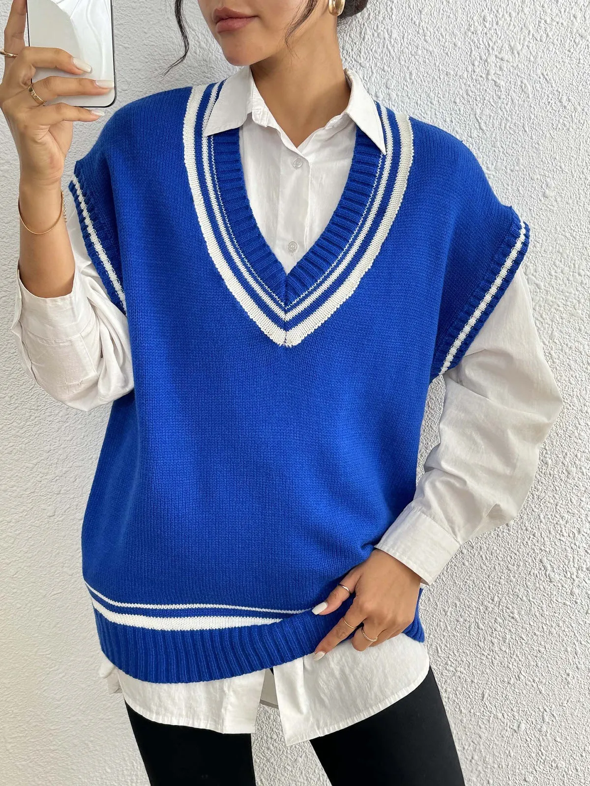 Women's college style wool vest sweater in loose fit pullover design showing black, blue and coffee colour options