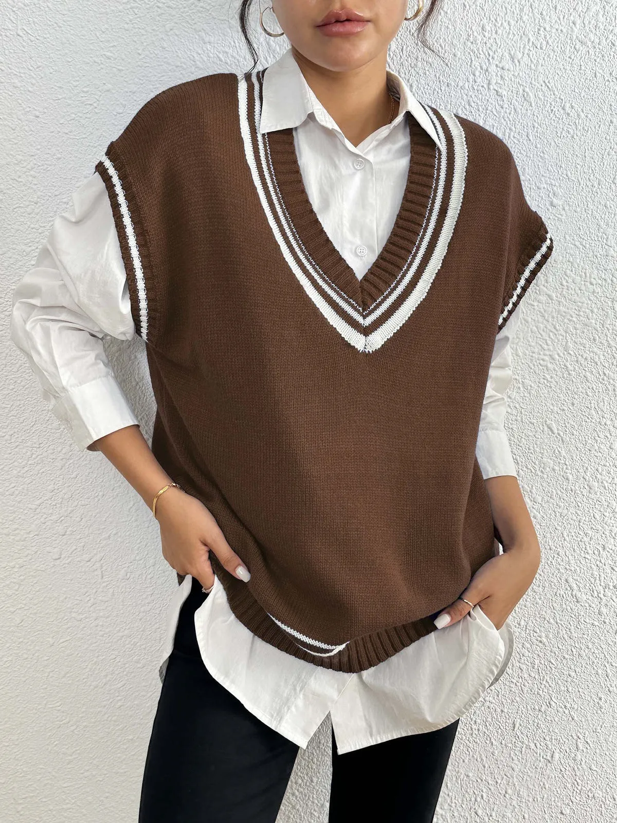 Women's college style wool vest sweater in loose fit pullover design showing black, blue and coffee colour options