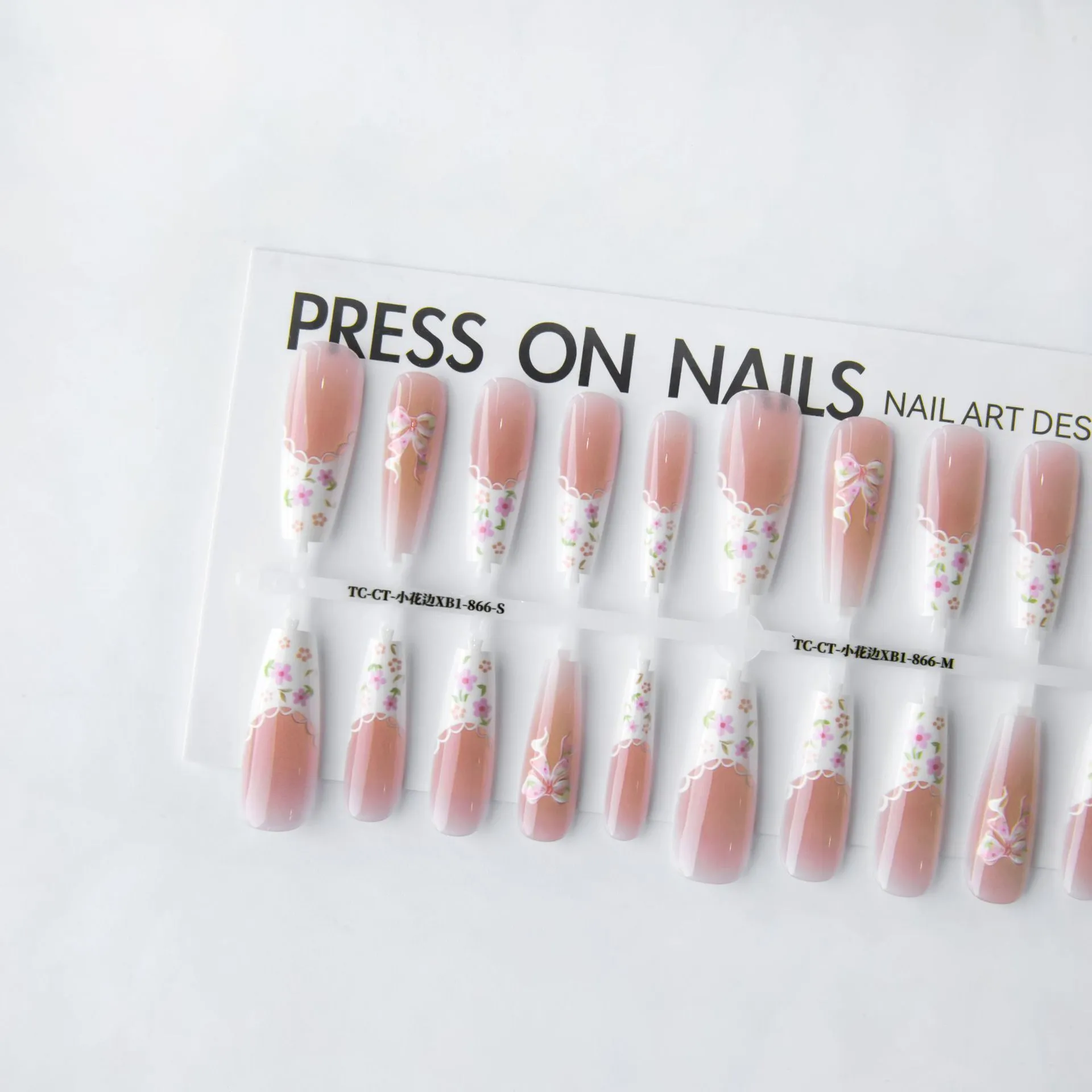Set of 40 small floral prefabricated nail tips with long ladder velvet seal layer in white, displayed on a flat surface