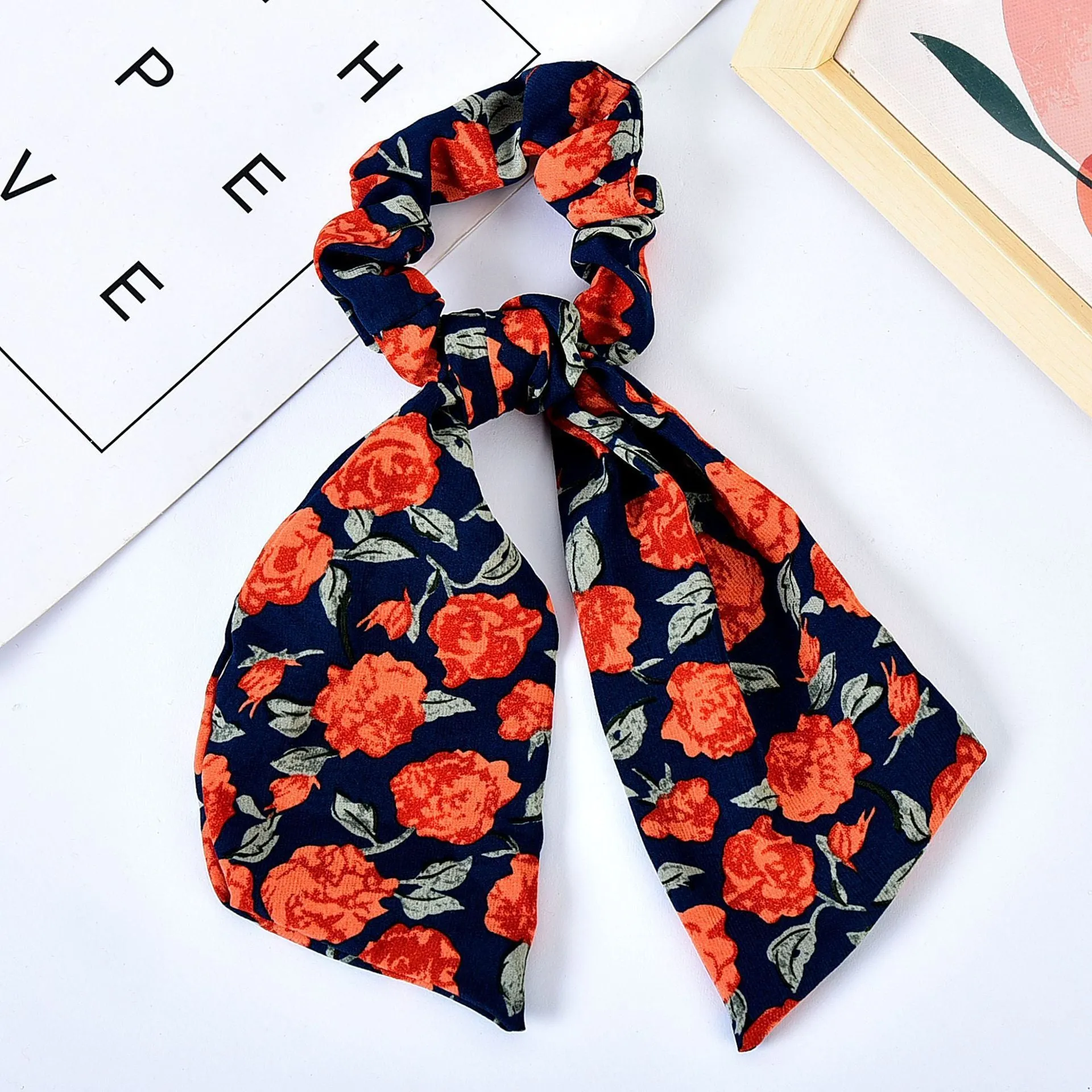 Pearl hair tie with bowknot and broken flower design in cloth material, available in multiple ribbon colours