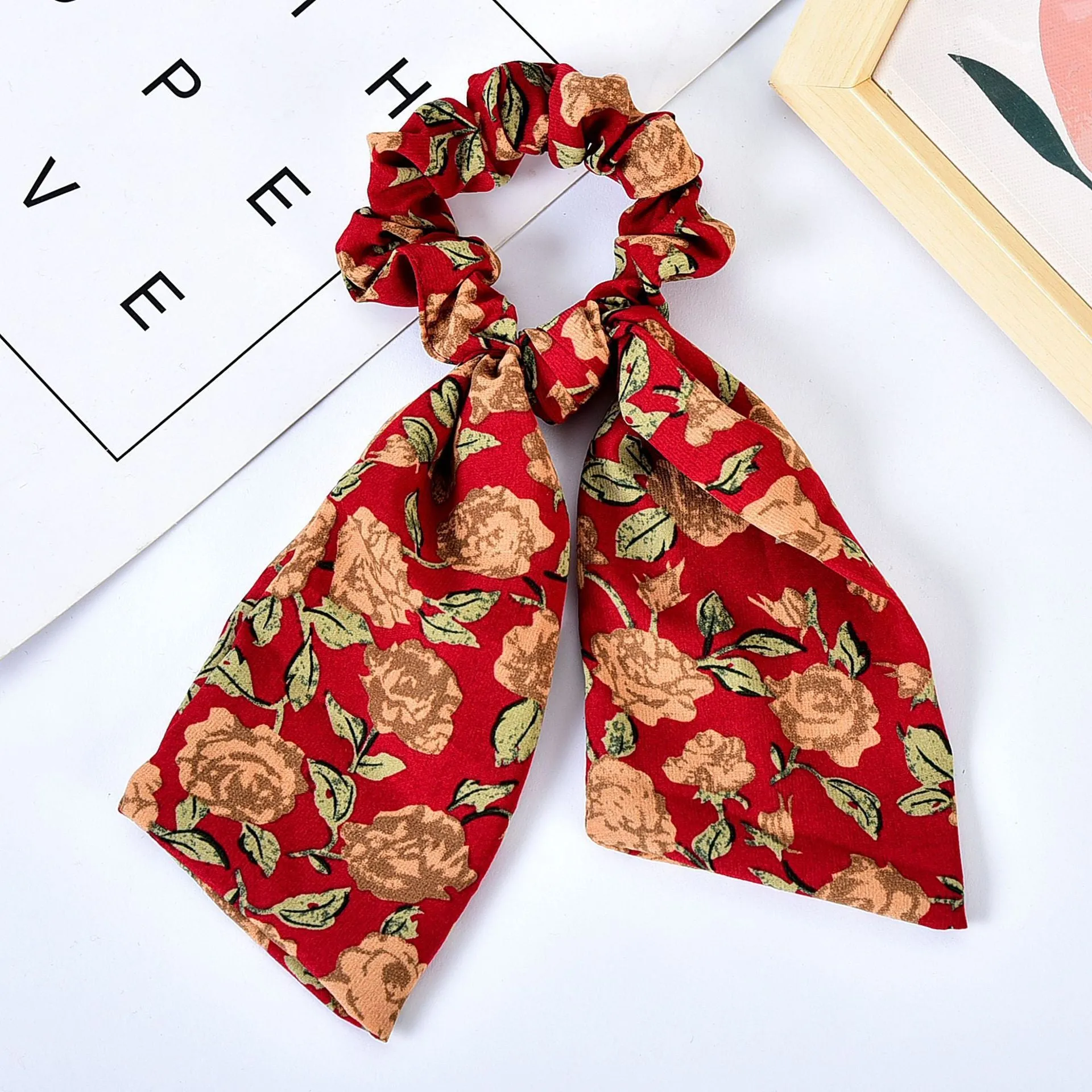 Pearl hair tie with bowknot and broken flower design in cloth material, available in multiple ribbon colours