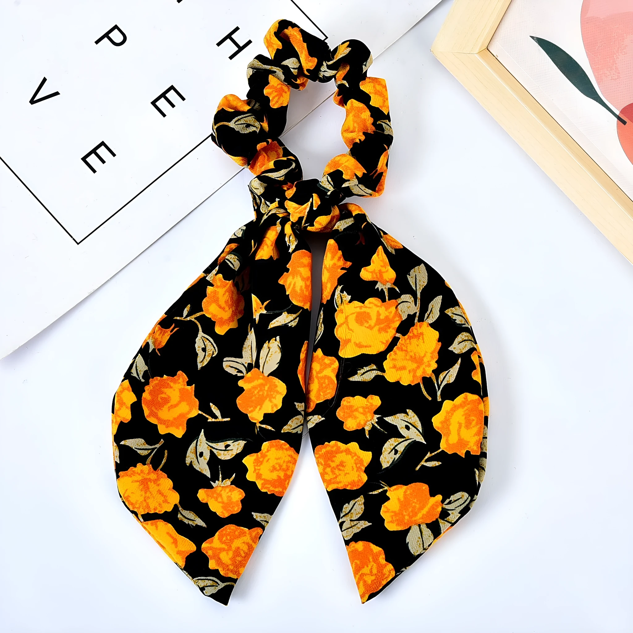 Pearl hair tie with bowknot and broken flower design in cloth material, available in multiple ribbon colours