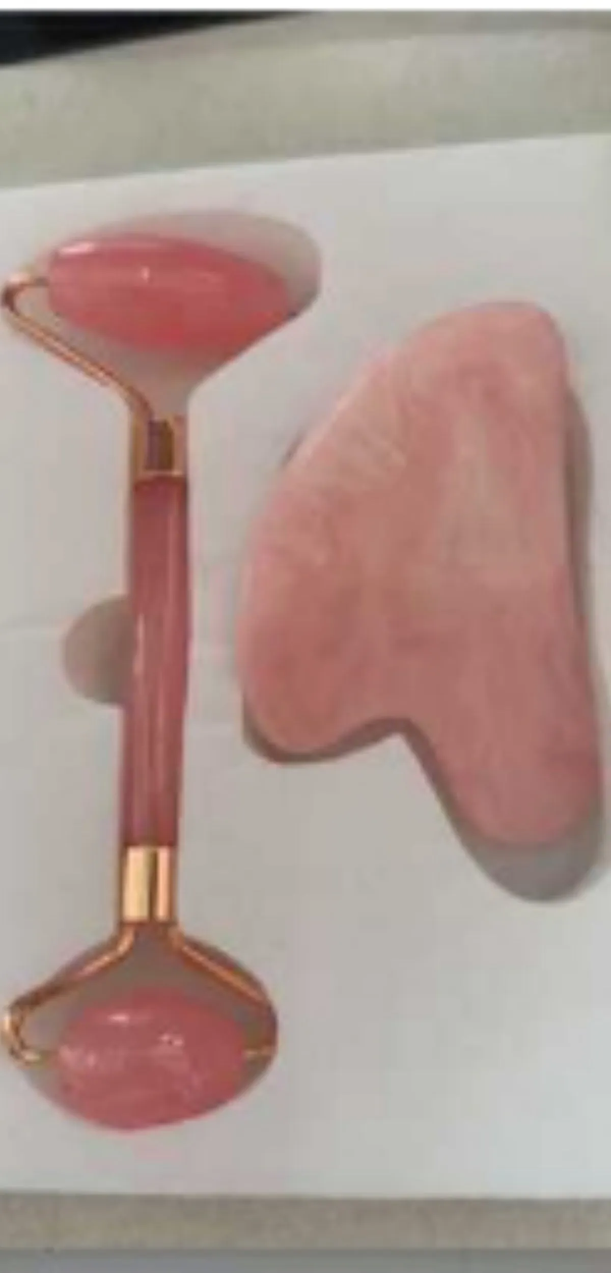 Two-piece resin gua sha roller set for face massage in black, pink, and green jade handle options