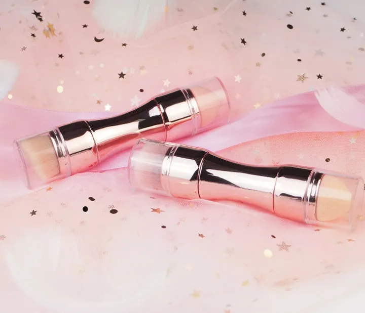 Four-in-one retractable makeup brush with gold handle and four brush heads on a white background