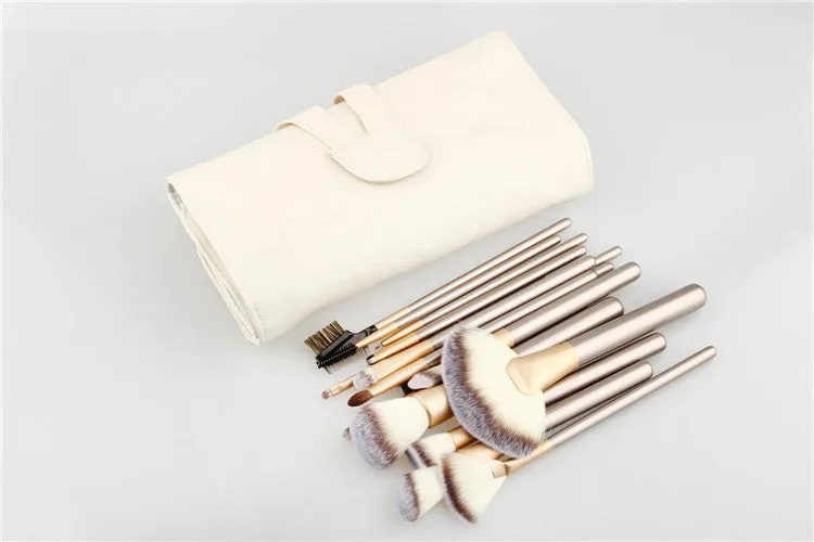 Champagne white synthetic fibre makeup brush set with wooden handles and aluminium ferrules on flat surface