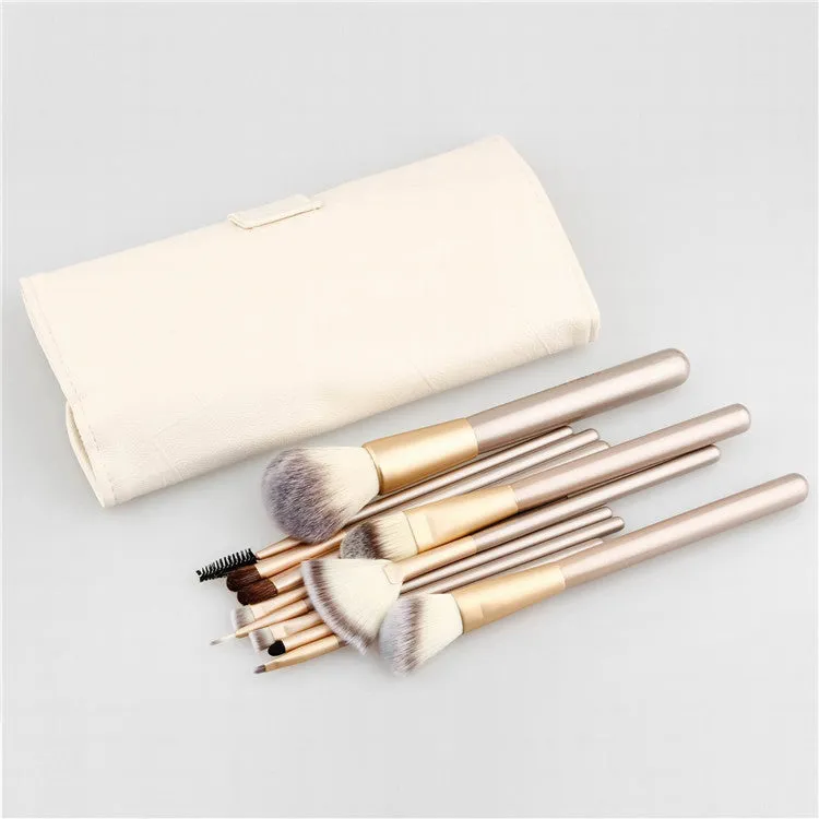 Champagne white synthetic fibre makeup brush set with wooden handles and aluminium ferrules on flat surface