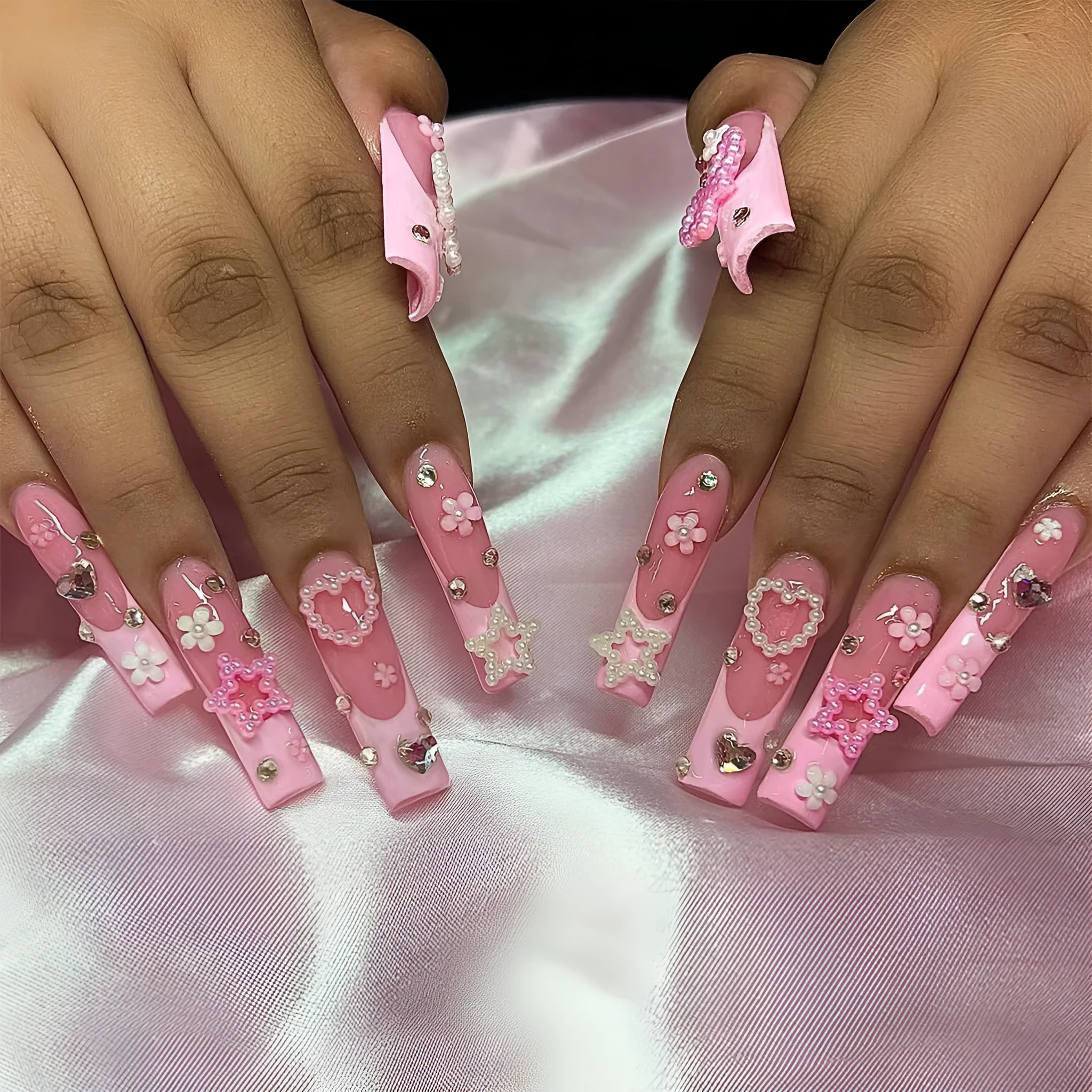 Long French style artificial nail with a decorative spot drill bow in a love pattern, colour XB-70-48.