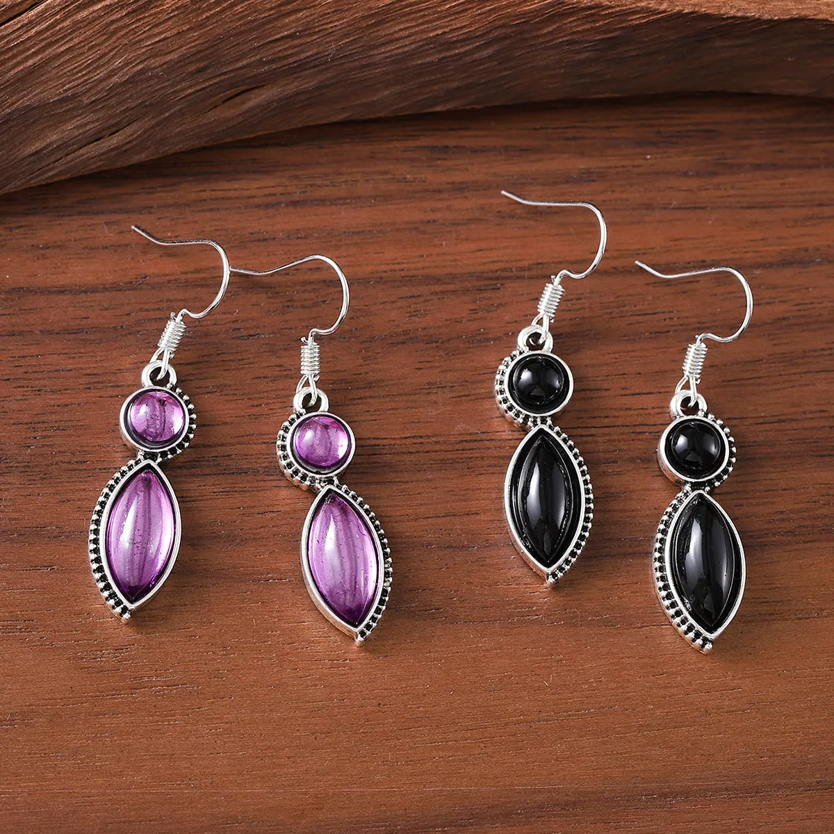 A pair of vintage geometric pendant earrings in black and purple with a round detail, made from zinc alloy.