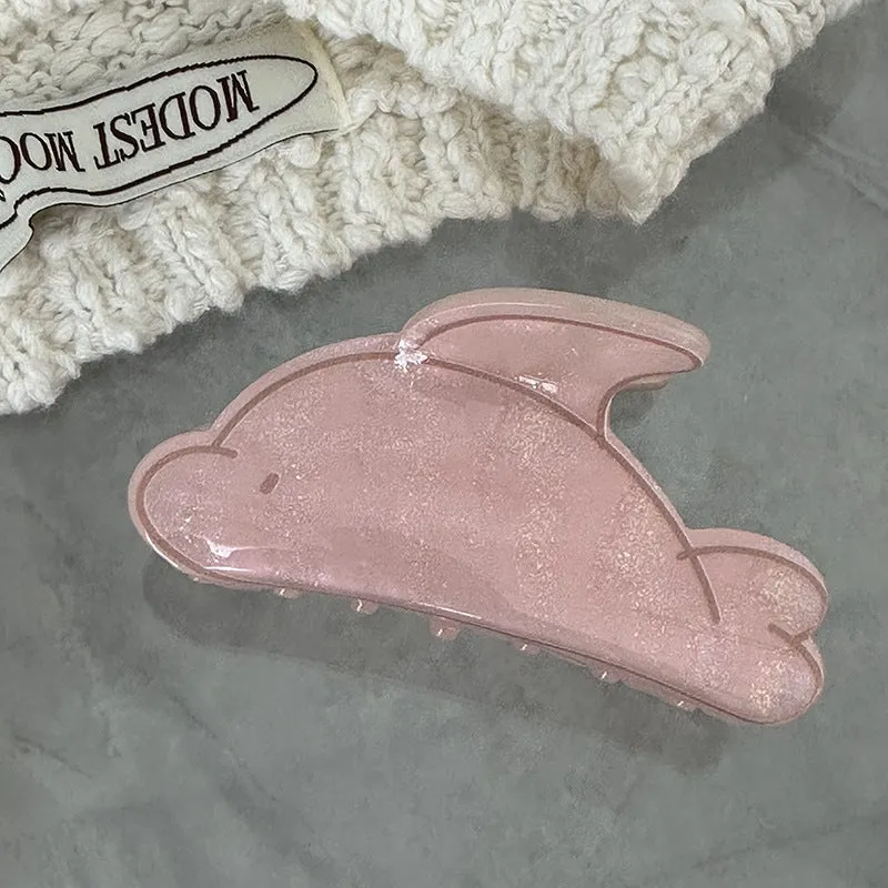 Women's dolphin grabber clip headdress in acetate material, available in blue and pink sizes, styled on hair