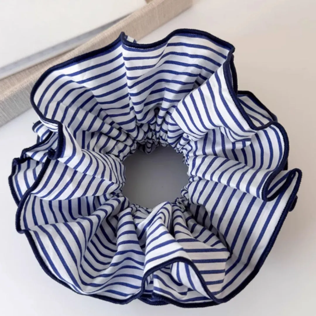 Blue striped fabric ball large intestine style stretch hairband on neutral background