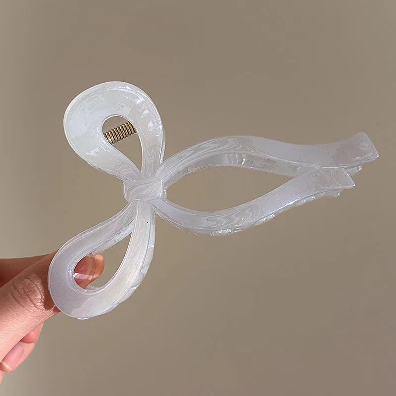 Women's ice bowknot resin hair clip with sweet bow design in blue, pink, and white colour options