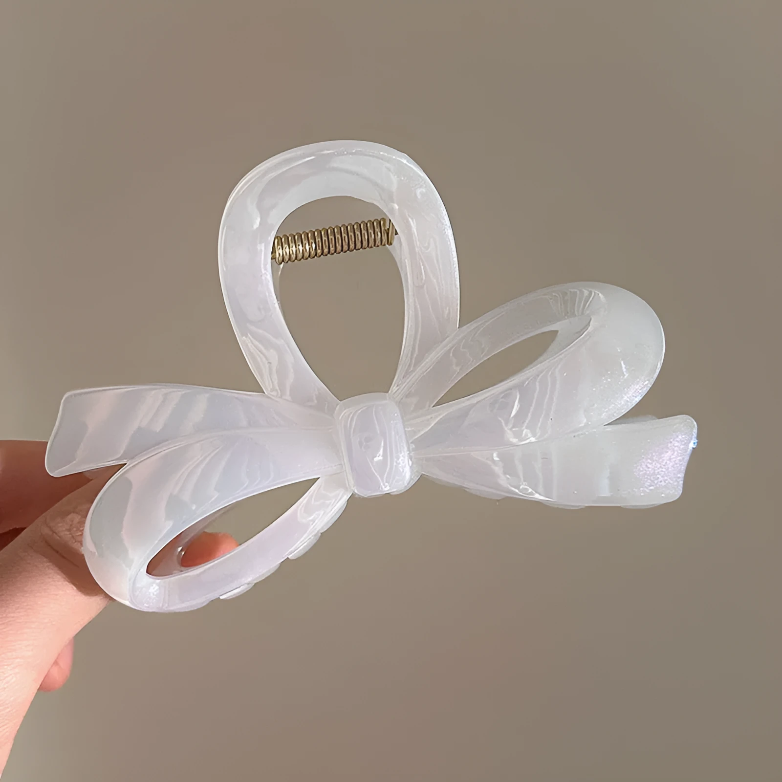 Women's ice bowknot resin hair clip with sweet bow design in blue, pink, and white colour options