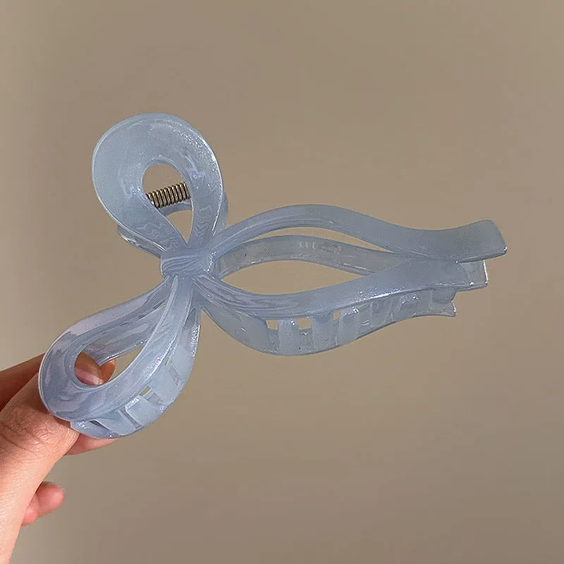 Women's ice bowknot resin hair clip with sweet bow design in blue, pink, and white colour options