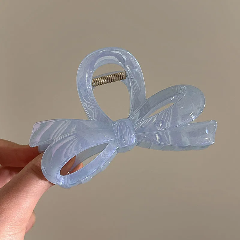 Women's ice bowknot resin hair clip with sweet bow design in blue, pink, and white colour options