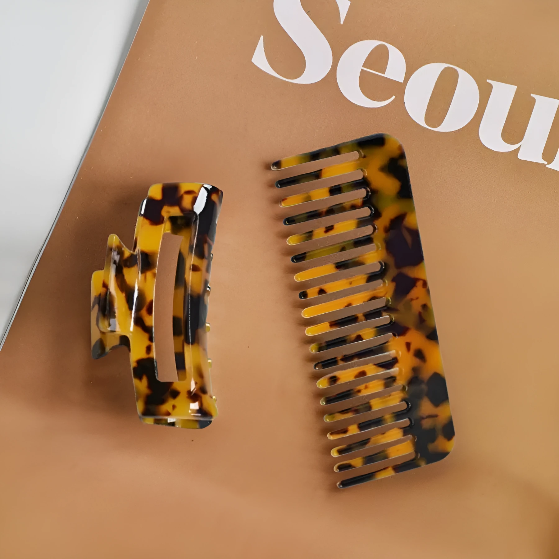 Acetic acid hair comb with wide teeth and matching holding clip in beige grain finish