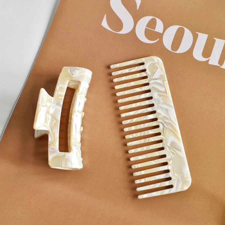 Acetic acid hair comb with wide teeth and matching holding clip in beige grain finish