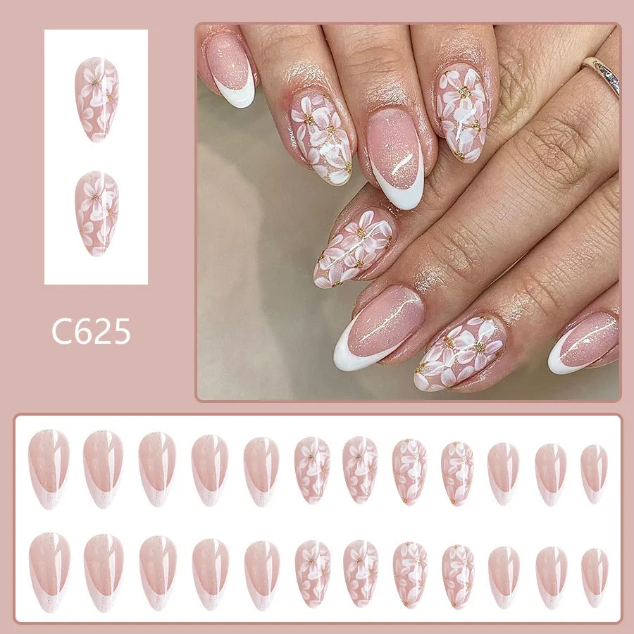 Short almond-shaped false nails with French style glitter and flower designs in colour C625