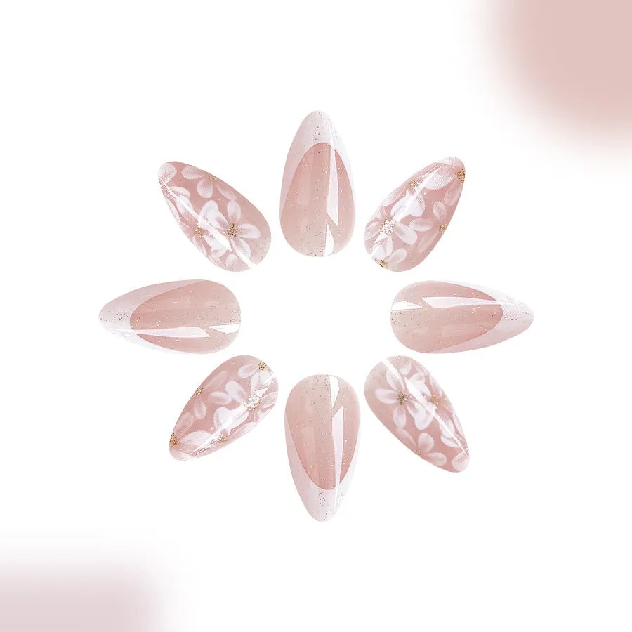 Short almond-shaped false nails with French style glitter and flower designs in colour C625