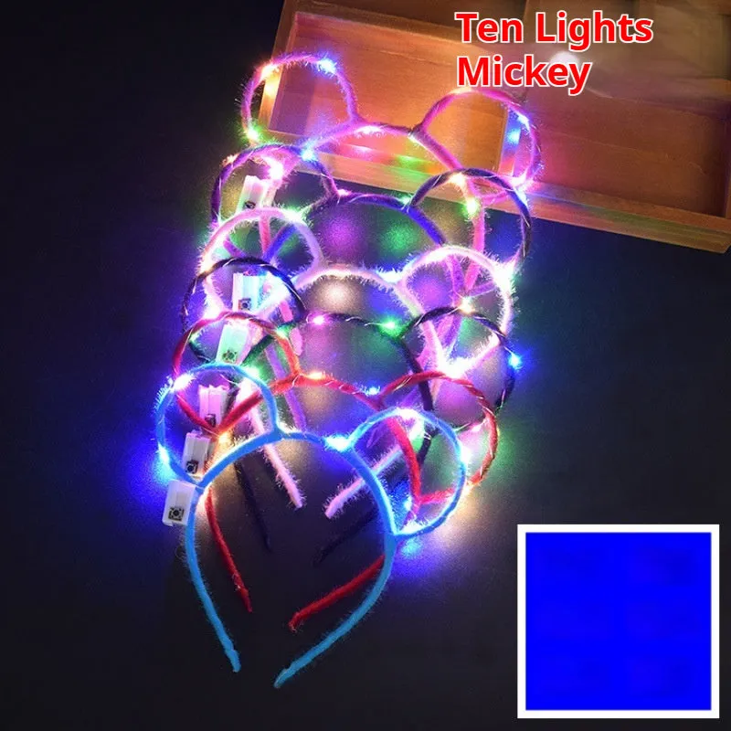 Glowing headdress antlers headband with LED lights on pink background, plastic construction with cat ears style