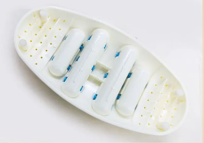 White dual foot acupressure massager roller for plantar fasciitis relief, with textured plastic surface