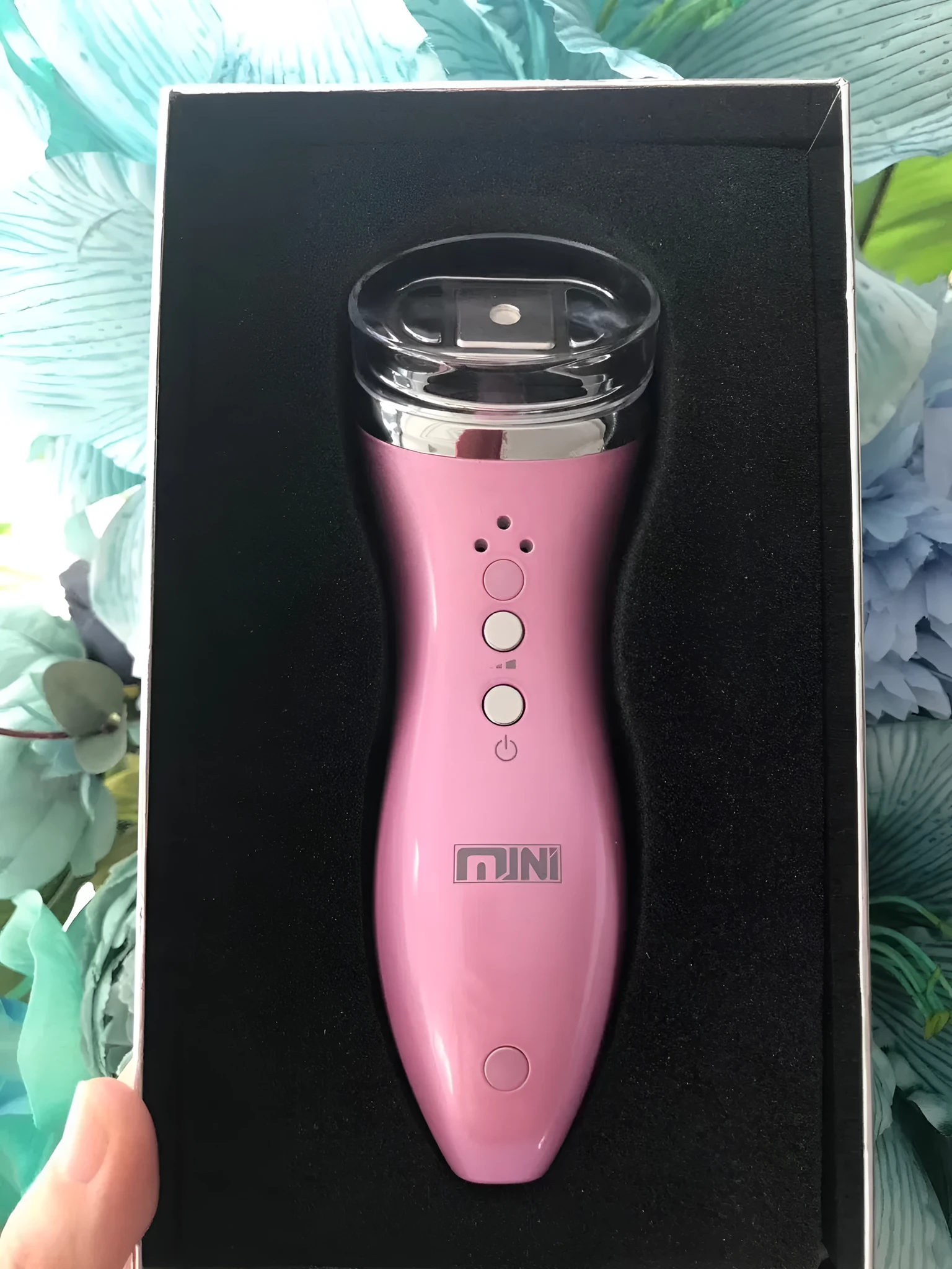 Mini ultrasonic scalpel home portable beauty device for facial firming in purple colour isolated on white background