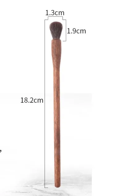 Set of 5 walnut eye makeup brushes with wool bristles on a flat surface.