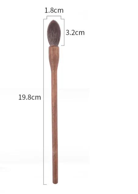 Set of 5 walnut eye makeup brushes with wool bristles on a flat surface.