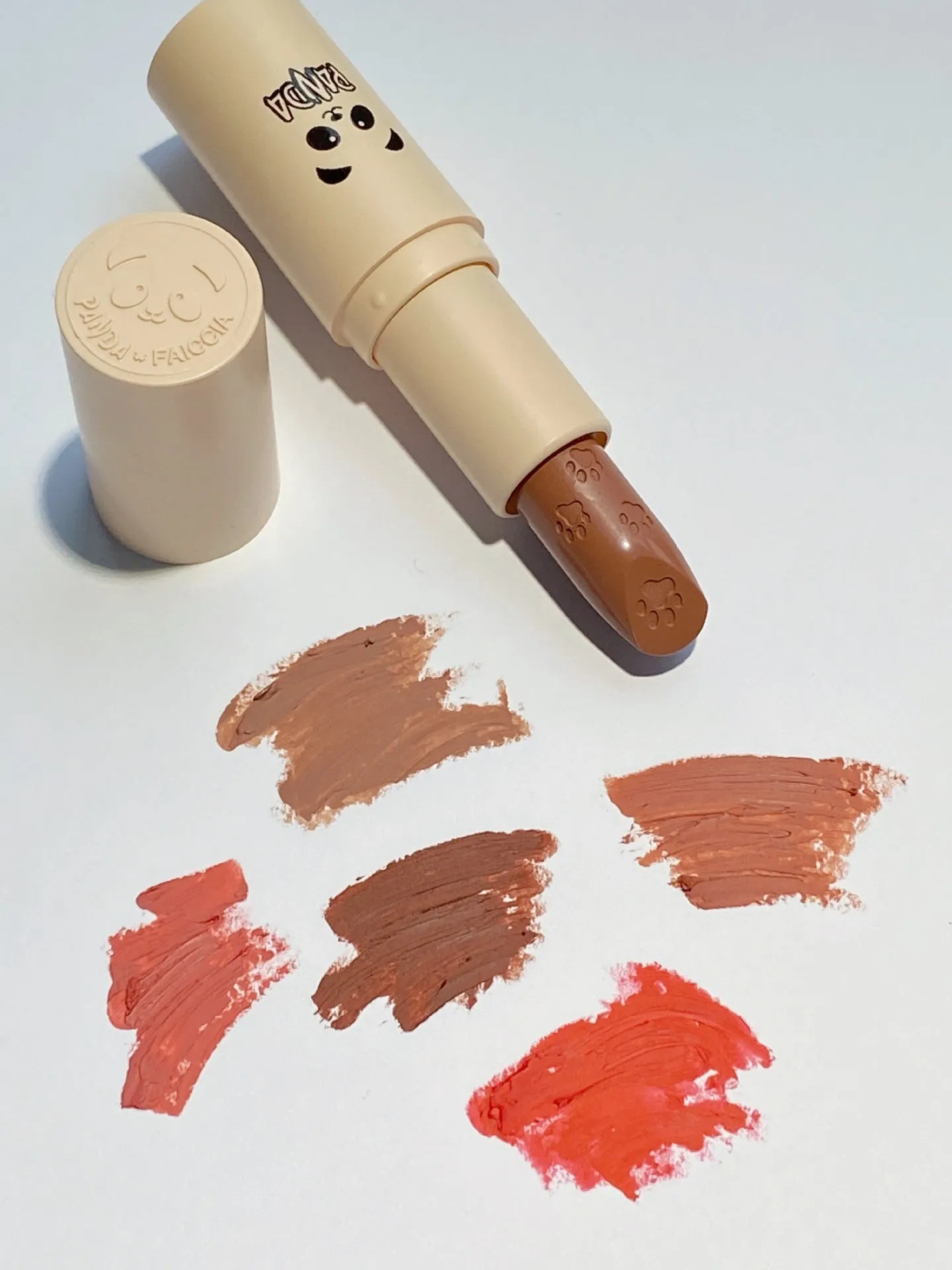Little white tube matte velvet lipstick with five colour swatches Almond Cinnamon, Amber orange brown, Dirty Orange, Jujube Red Brown, White Peach Bean Paste