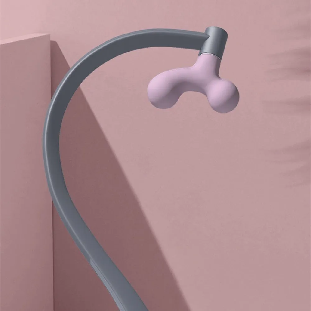 Light purple plastic scapula seam massager hook on a neutral surface
