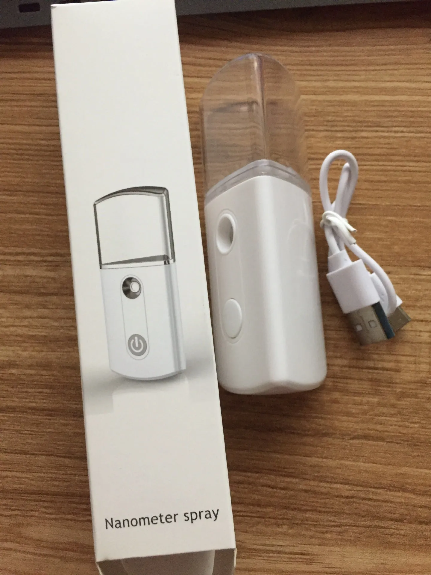 Portable facial nano mist humidifier in white, 10cm long, with 20ml water tank and USB cable