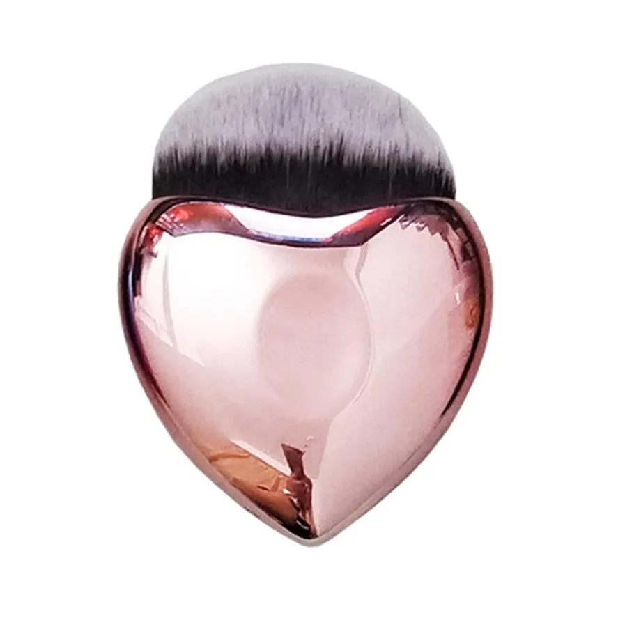 Heart-shaped portable foundation brush with soft bristles for blush and contour application, on a clean background