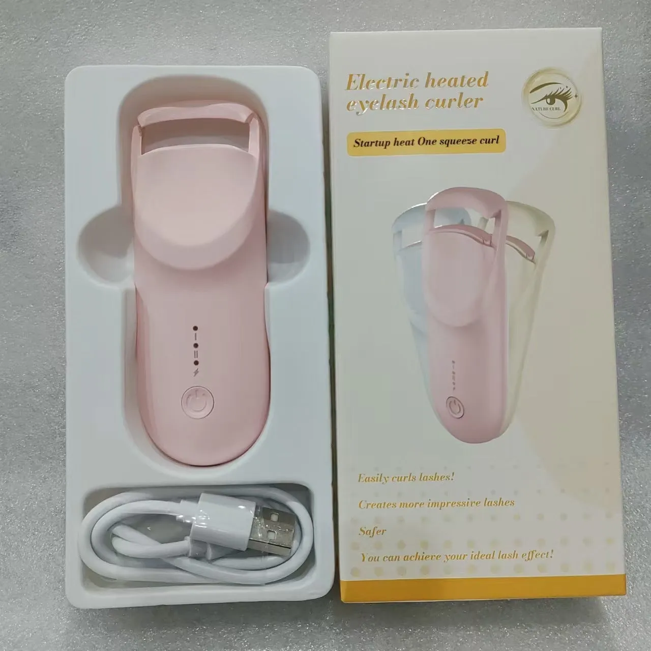 Electric USB-rechargeable eyelash curler in cream white, pink, and apricot colour options.