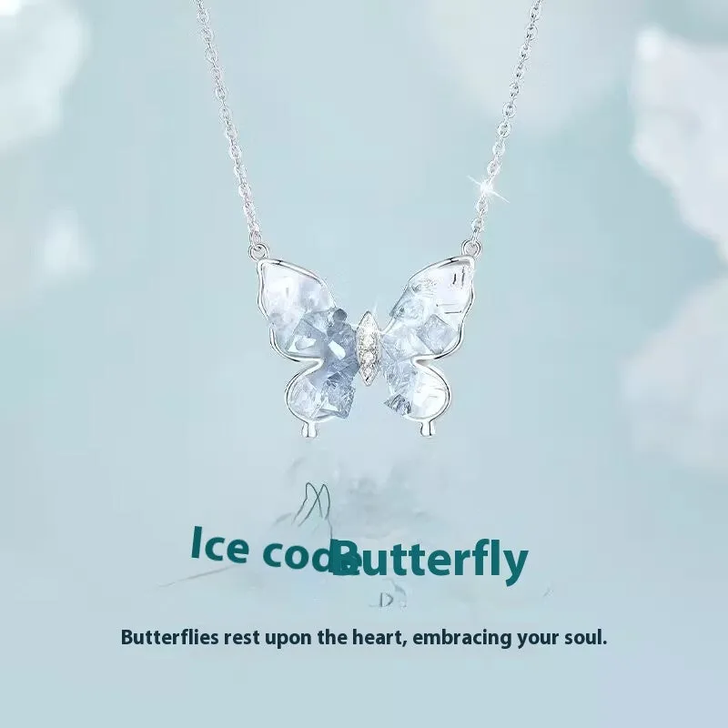 Close-up of a silver necklace with a detailed ice rain butterfly pendant on an O-ring chain.