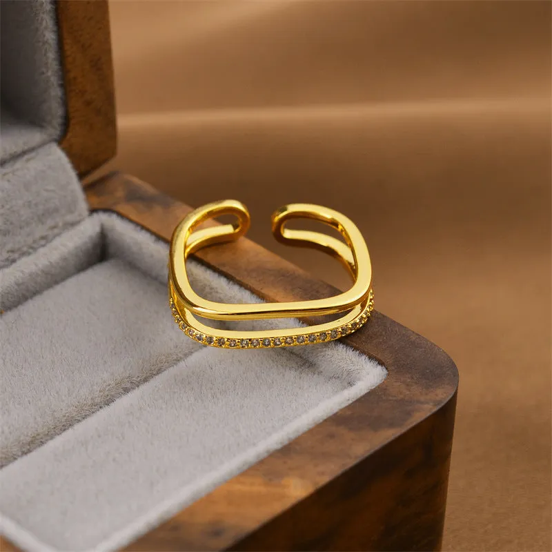 Gold geometric open adjustable ring for women on a white background.