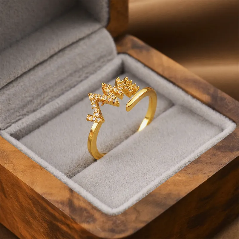 Gold geometric open adjustable ring for women on a white background.