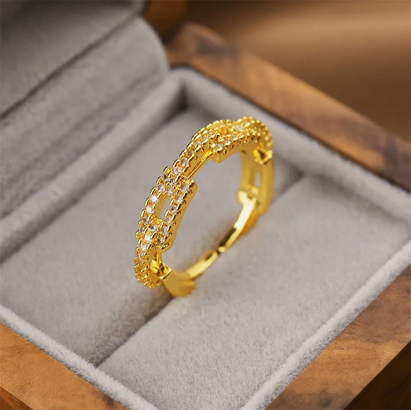 Gold geometric open adjustable ring for women on a white background.