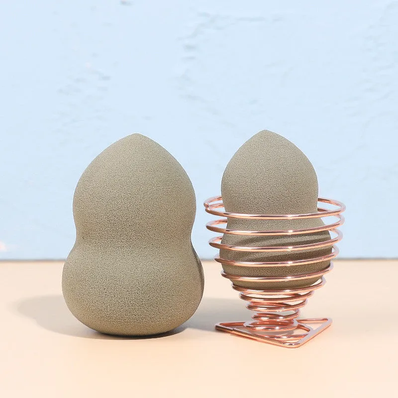 Four coloured hydrophilic polyurethane beauty eggs placed on a metal stand for makeup application