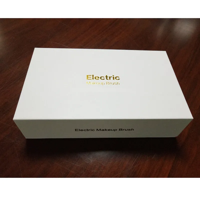 Electric makeup brush with white body, fibre wool bristles, and two rounded brush heads including foundation and blush applicators
