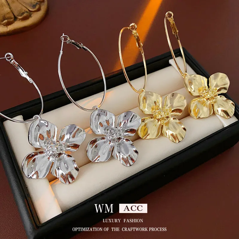 Geometric flower-shaped alloy earrings with a gold or silver electroplated finish.