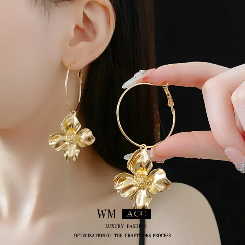 Geometric flower-shaped alloy earrings with a gold or silver electroplated finish.