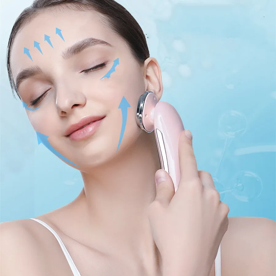 Pink and white rechargeable facial massager with red and blue light therapy functions on a clean surface