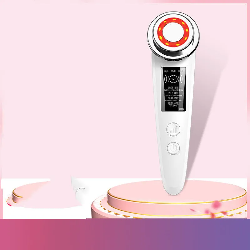 Pink and white rechargeable facial massager with red and blue light therapy functions on a clean surface