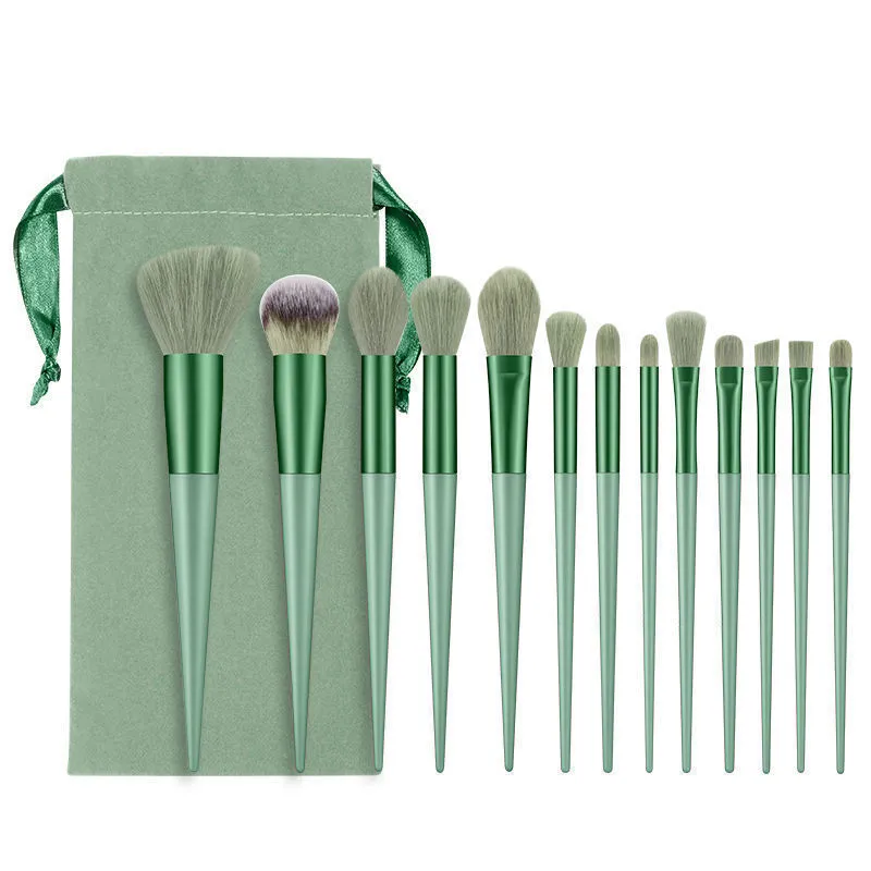 13-piece Wizard of Oz green makeup brush set with man-made fibre bristles and wooden handles in cloth bag