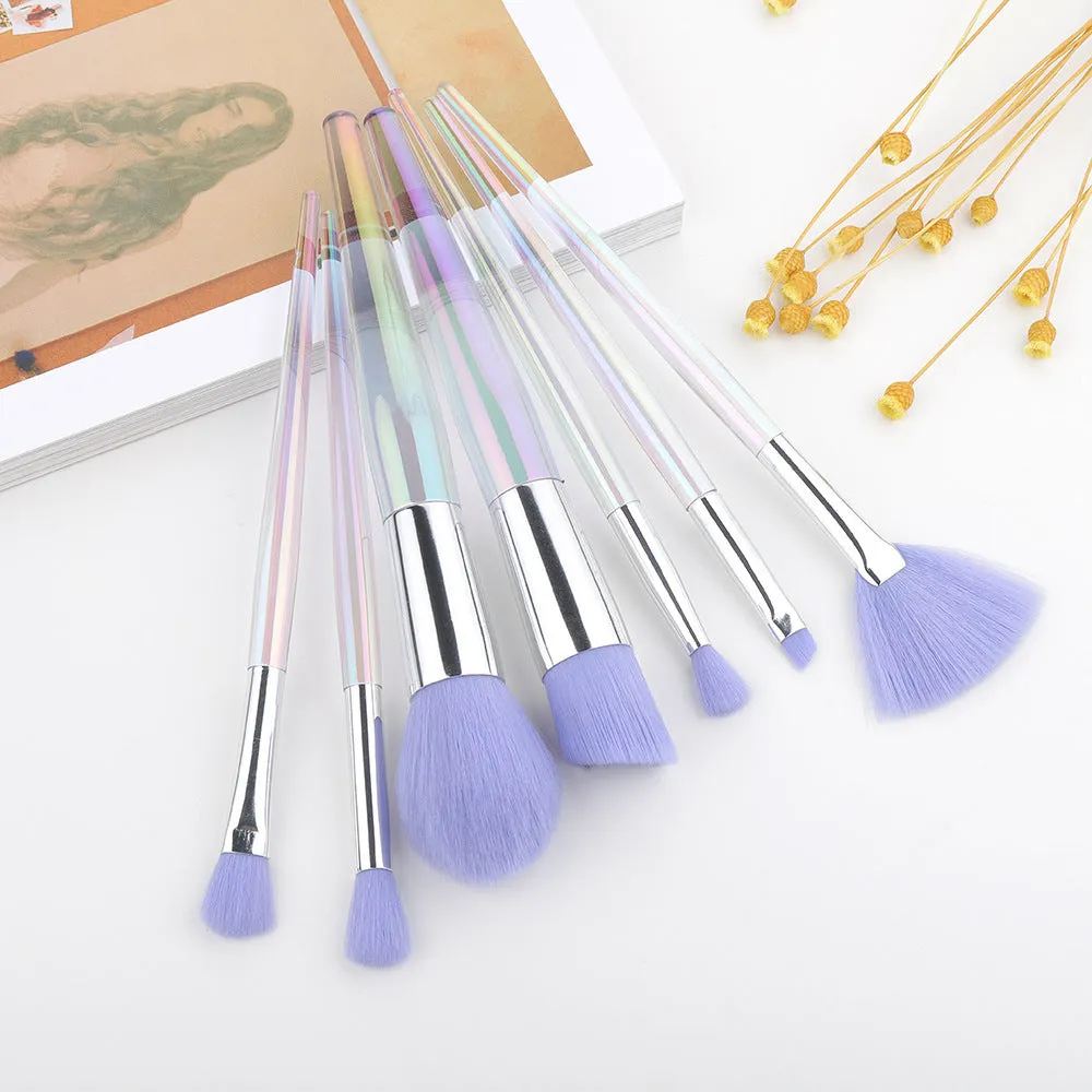 Water drop pattern makeup brush set of seven brushes with blue gold pink purple and transparent handles on white background