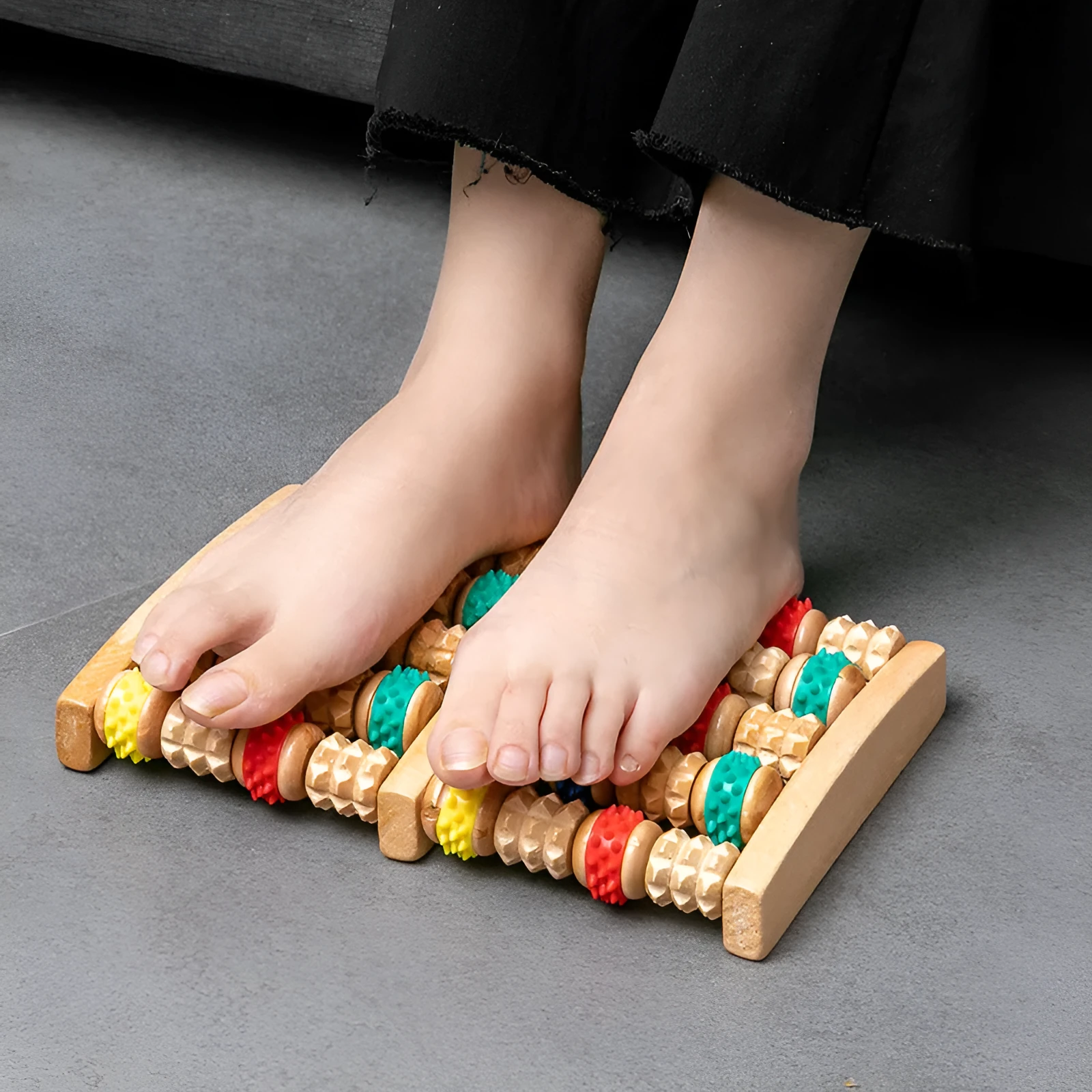 Wooden six-row roller foot massager for acupoint hand massage on a flat surface