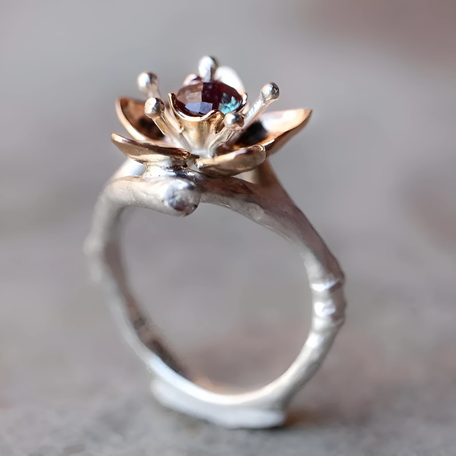A two-tone silver women's ring with a geometric band and a floral ornament.
