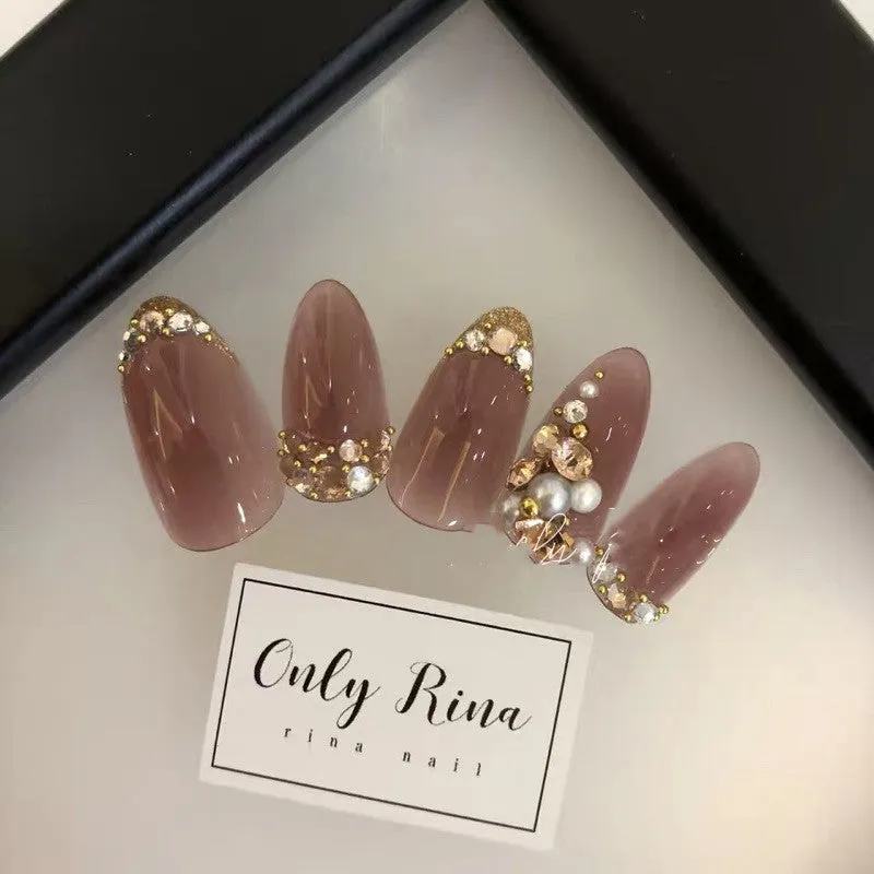 Handmade manicure finished fake nails in light brown colour for bride wear
